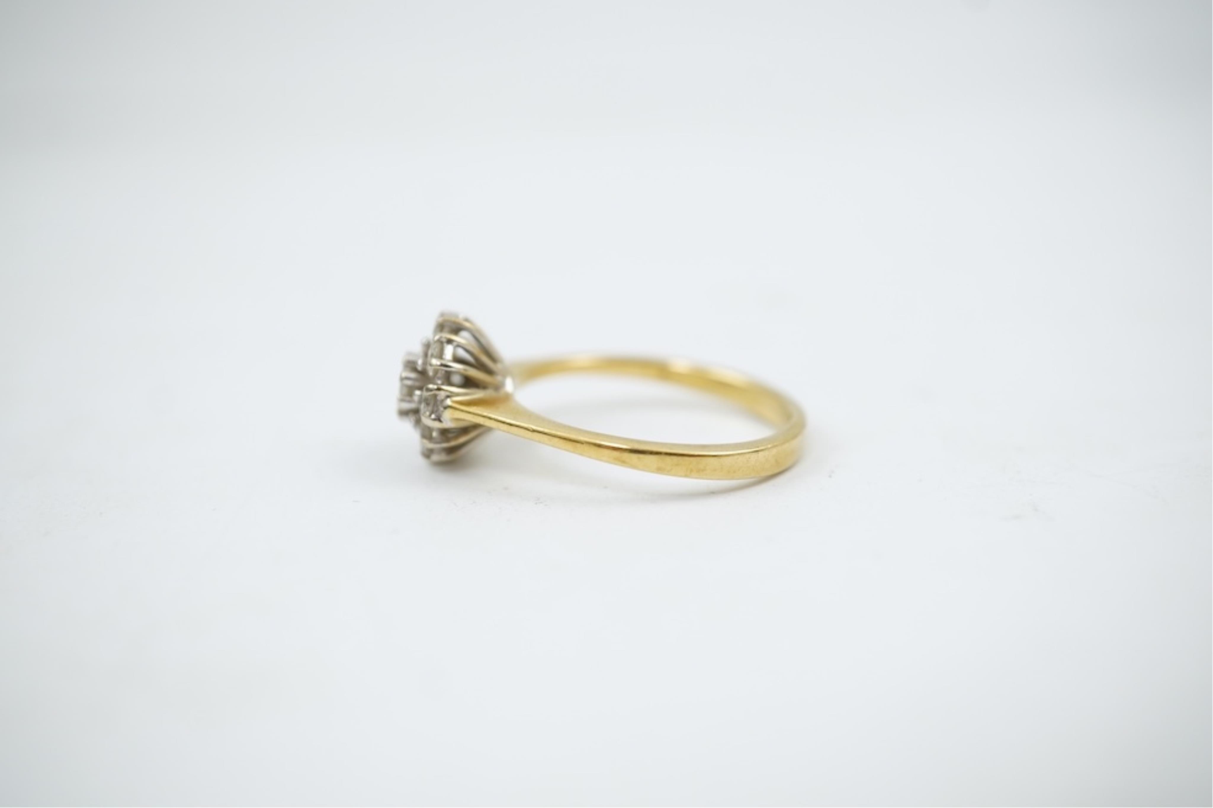 A modern 18ct gold and diamond set circular cluster ring, size M, gross weight 3.2 grams.